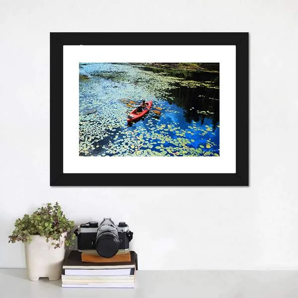 Canoeing In Water Lilies Canvas Wall Art