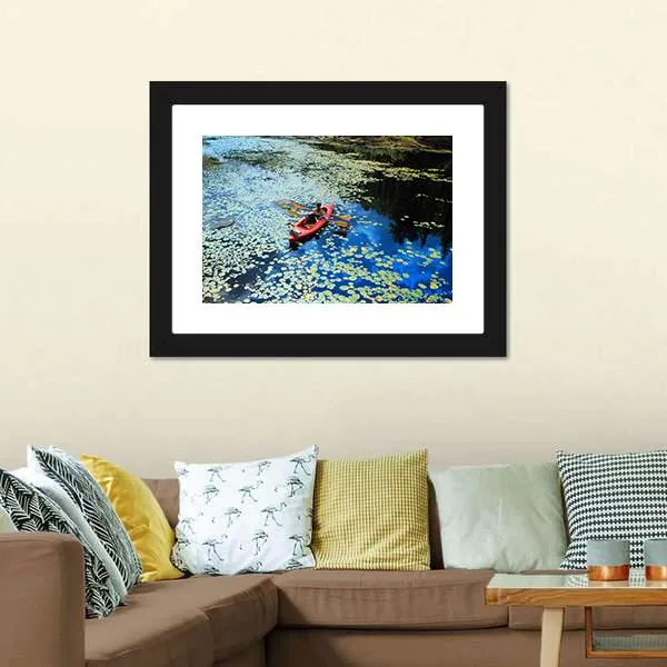 Canoeing In Water Lilies Canvas Wall Art