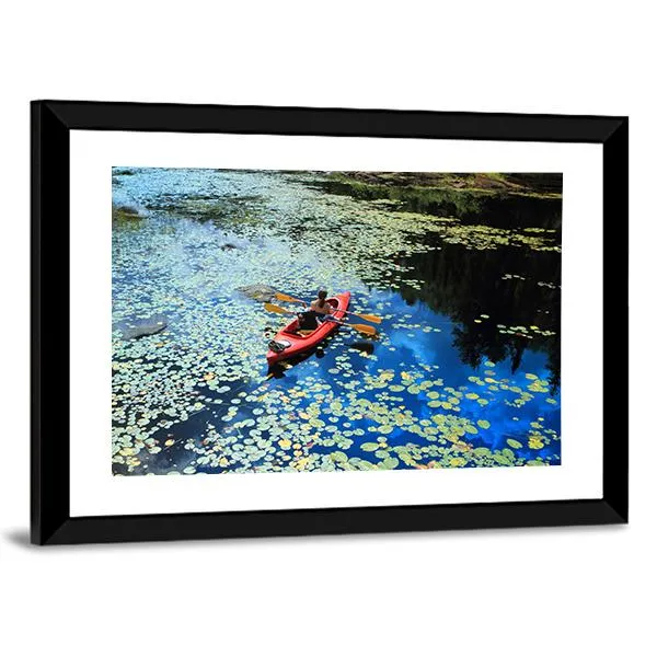 Canoeing In Water Lilies Canvas Wall Art