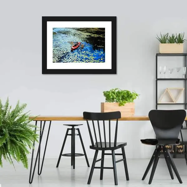 Canoeing In Water Lilies Canvas Wall Art